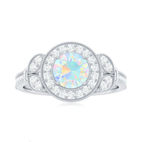 Vintage inspired Ethiopian rainbow opal engagement ring with diamond halo from Rosec Jewels, featuring colorful gemstone and elegant design.