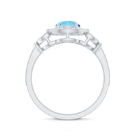 Vintage-inspired aquamarine engagement ring with diamond halo from Rosec Jewels, featuring a central aquamarine stone and surrounding diamonds.