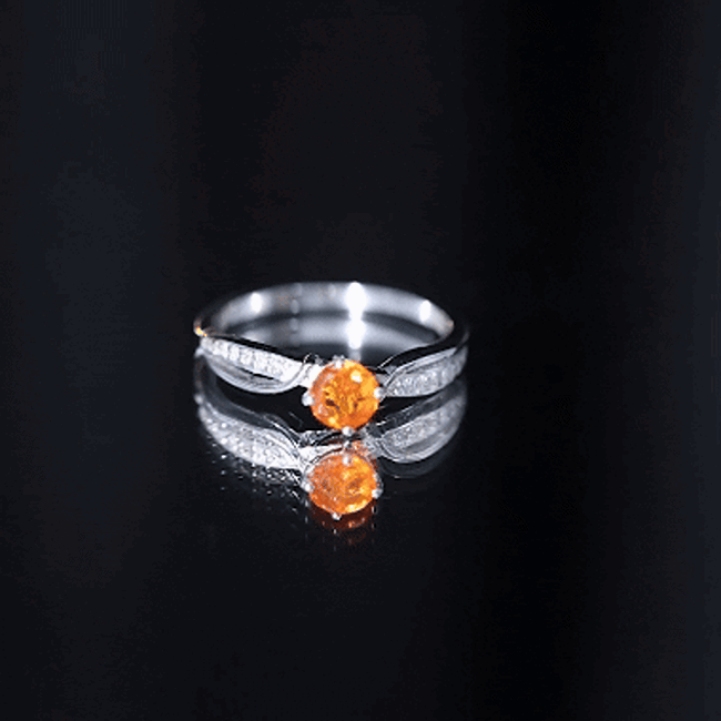 Yellow-orange Fire Opal infinity engagement ring with diamonds by Rosec Jewels, showcasing a sparkling gemstone and elegant band.