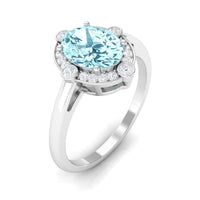 Rosec Jewels 1 Carat Aquamarine oval halo engagement ring with diamond accents, showcasing intricate design and sparkling gemstones.