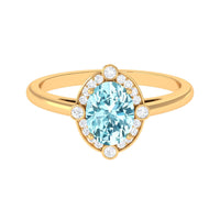 Oval 1 Carat aquamarine engagement ring with diamond halo, featuring rose gold band and intricate detailing, by Rosec Jewels.