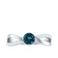 Rosec Jewels London Blue Topaz proposal ring with sparkling diamonds, showcasing a stunning blue gemstone and elegant band.