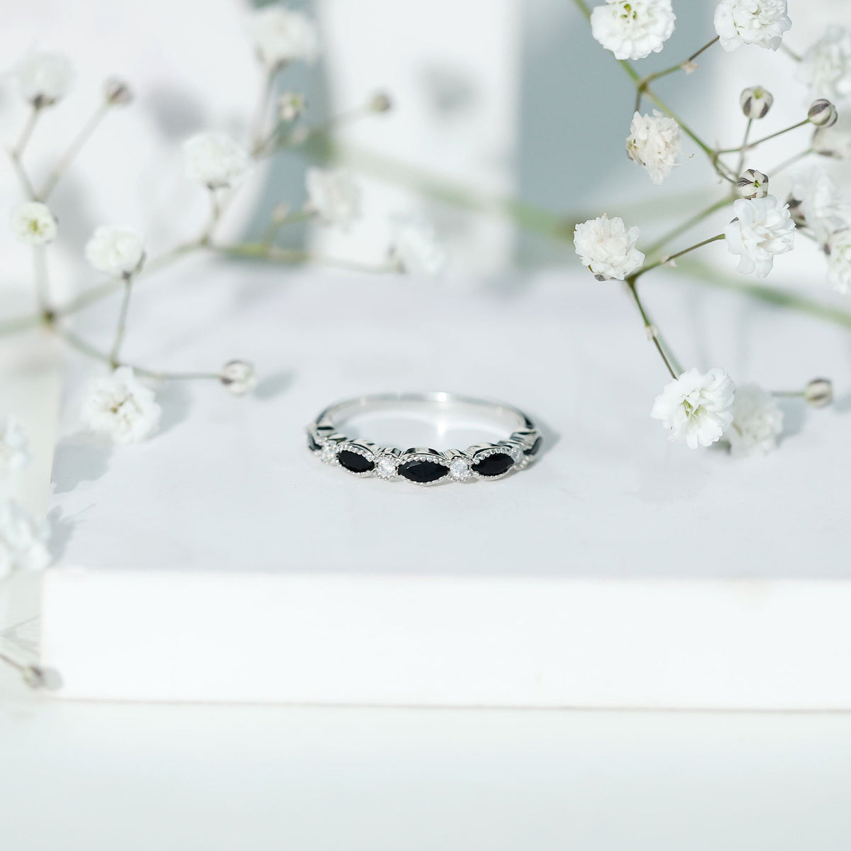 Natural marquise cut black onyx half eternity ring by Rosec Jewels featuring a continuous band of black onyx stones.