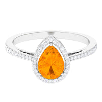 Real 0.6 carat fire opal teardrop engagement ring with diamond halo, featuring a rose gold band and intricate design.