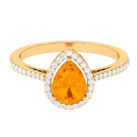 Real 0.6 carat fire opal teardrop engagement ring with diamond halo by Rosec Jewels, showcasing the elegant gemstone setting.