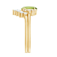Oval peridot engagement ring with diamond wedding band from Rosec Jewels, showcasing the sparkling gemstone and elegant metal setting.