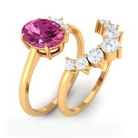 Oval pink tourmaline and diamond wedding ring set with rose gold bands, featuring intricate detailing and sparkling gemstones.