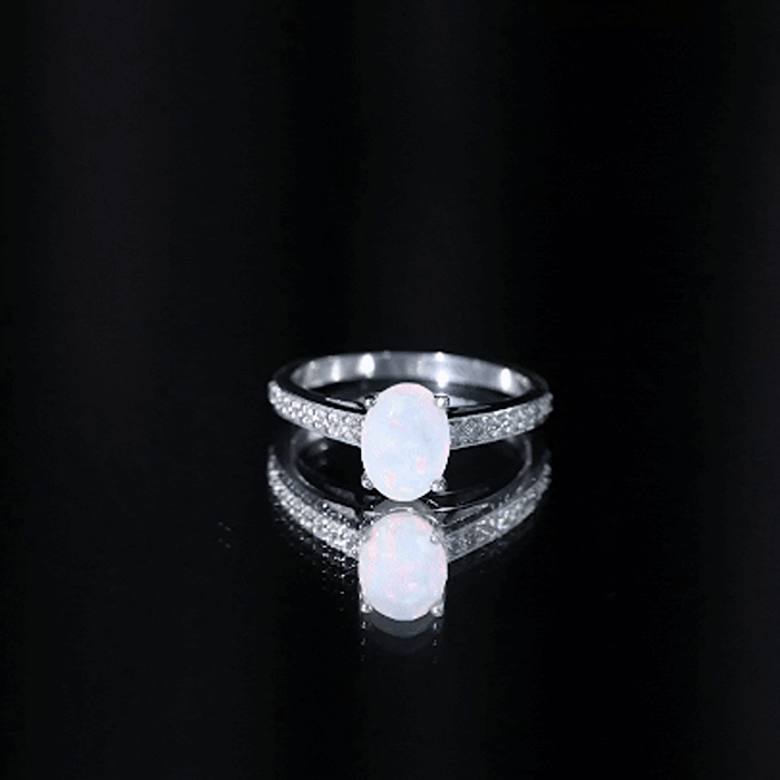 Oval Ethiopian opal engagement ring with diamond side stones, featuring a natural 1.2 carat opal in a Rosec Jewels ring setting