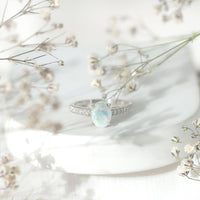 Natural 1.2 Carat Ethiopian Opal oval engagement ring with diamond side stones from Rosec Jewels, showcasing a stunning gemstone and elegant design.