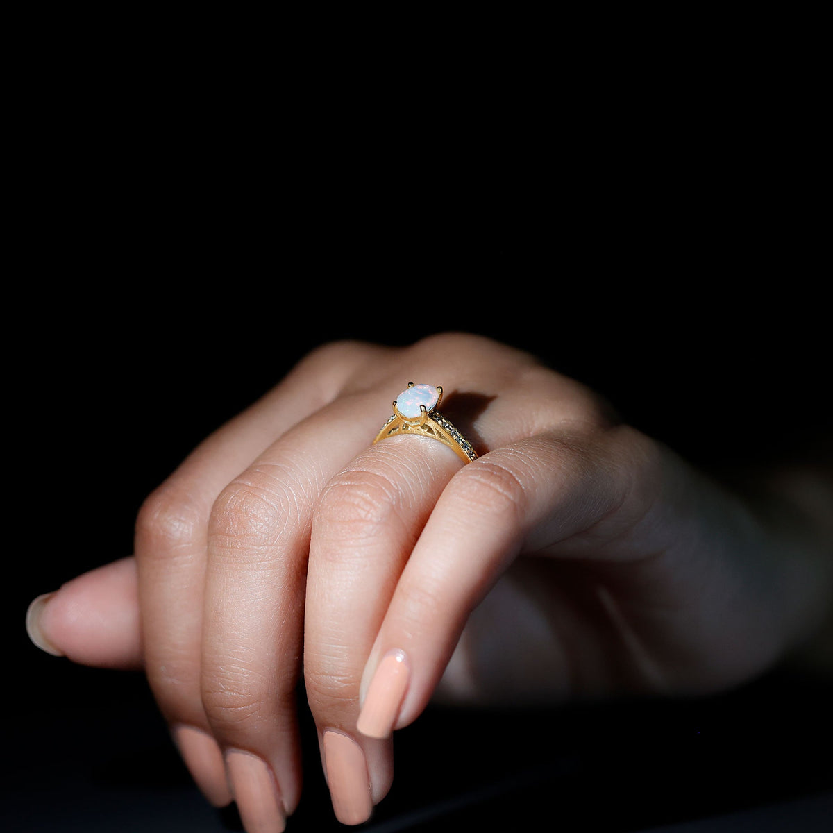 Natural 1.2 carat Ethiopian opal oval engagement ring with diamond side stones, featuring a rose gold band and intricate design.