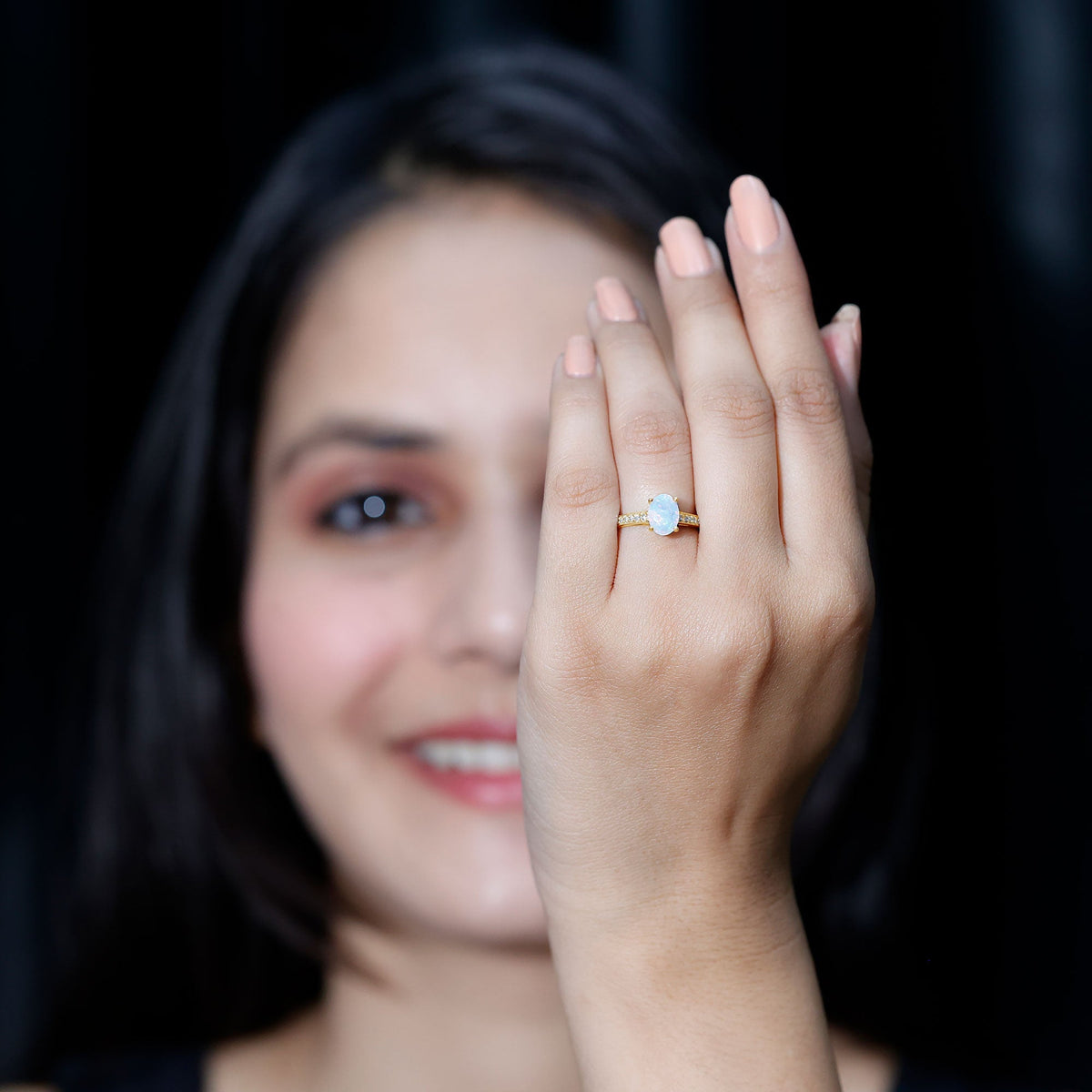 Natural 1.2 carat Ethiopian opal oval engagement ring with diamond side stones, featuring a silver band and intricate setting.
