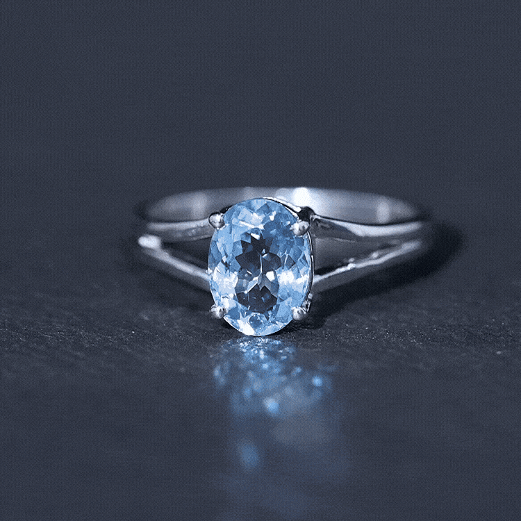 Genuine oval aquamarine solitaire engagement ring with split shank design from Rosec Jewels, showcasing the elegant gemstone setting.