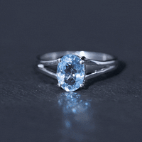 Genuine oval aquamarine solitaire engagement ring with split shank design from Rosec Jewels, showcasing the elegant gemstone setting.