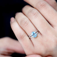 Genuine oval aquamarine solitaire engagement ring with split shank design by Rosec Jewels, showcasing the elegant gemstone setting.