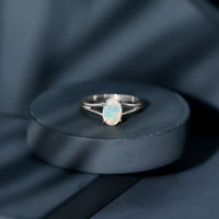 Oval Ethiopian rainbow opal engagement ring with split shank design, set in a 1.2 carat genuine gemstone by Rosec Jewels