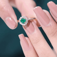 Round emerald and diamond engagement ring by Rosec Jewels featuring a classic design with sparkling gemstones.