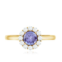 Genuine Tanzanite engagement ring with diamond halo and silver band, featuring intricate detailing and a sparkling center stone.