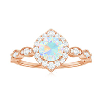 Vintage Ethiopian opal engagement ring with real diamond halo, featuring intricate design and sterling silver band from Rosec Jewels.