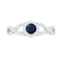 Criss cross shank blue sapphire and diamond halo engagement ring by Rosec Jewels, featuring a central sapphire with surrounding diamonds.