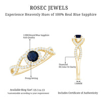 Criss cross shank blue sapphire and diamond halo engagement ring by Rosec Jewels, featuring a central sapphire surrounded by diamonds.