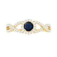 Blue sapphire and diamond halo engagement ring with criss-cross shank by Rosec Jewels, showcasing intricate detailing and sparkling stones.