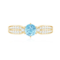 Elegant aquamarine engagement ring with diamond side stones from Rosec Jewels, showcasing a sparkling blue gemstone and intricate band design.