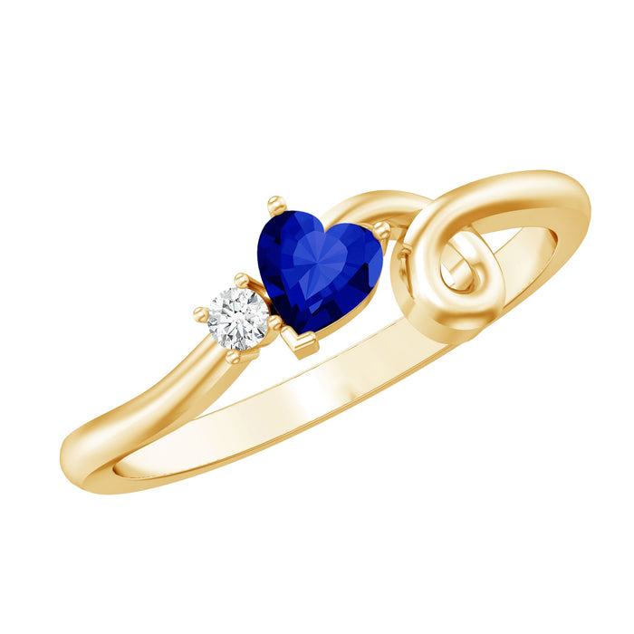 Sterling silver twisted heart promise ring with a blue lab-grown sapphire, showcasing elegant craftsmanship by Rosec Jewels.