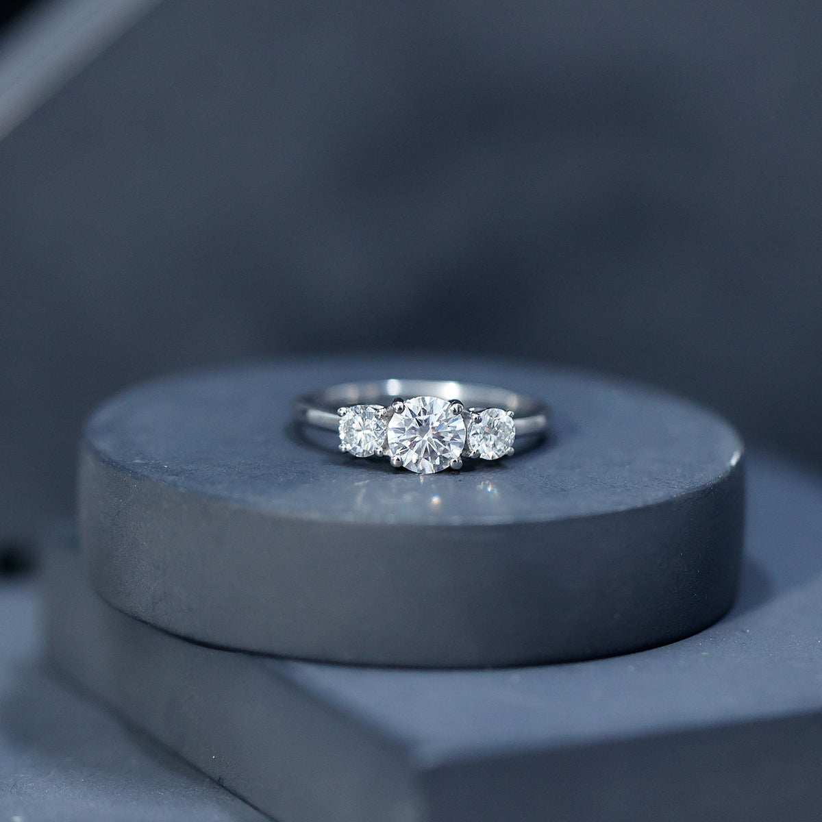 Certified Moissanite three-stone engagement ring for her with rose gold band, featuring sparkling gemstones from Rosec Jewels.