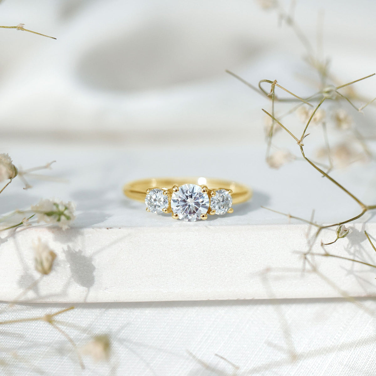 Certified Moissanite three-stone engagement ring for her, featuring sparkling stones and a polished silver band by Rosec Jewels.