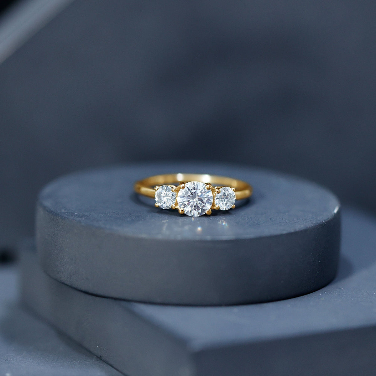 Certified Moissanite three-stone engagement ring for her featuring a rose gold band and sparkling stones from Rosec Jewels.