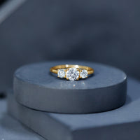 Certified Moissanite three-stone engagement ring for her featuring a rose gold band and sparkling stones from Rosec Jewels.
