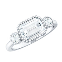 Emerald cut moissanite three-stone engagement ring with east-west setting by Rosec Jewels, featuring sparkling center stones and elegant band.