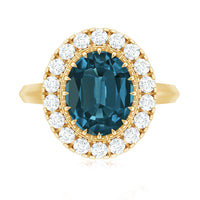 Rosec Jewels London Blue Topaz engagement ring with a central blue topaz gemstone and diamond accents, showcasing elegant craftsmanship.