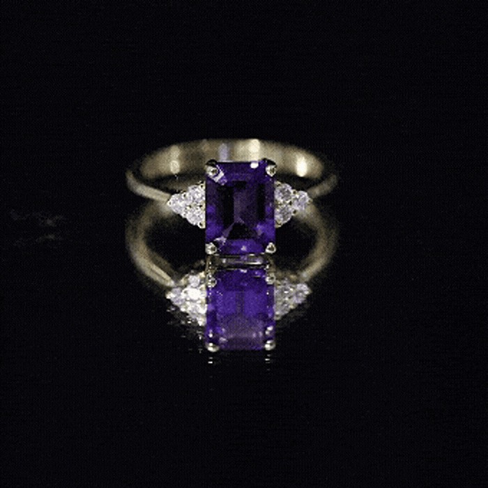 Emerald cut 1.4 carat amethyst engagement ring with diamond trio setting by Rosec Jewels, showcasing a sparkling purple gemstone and elegant band.
