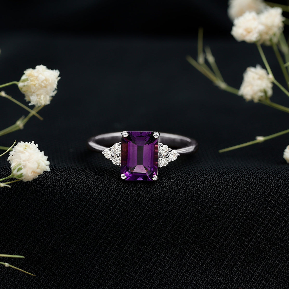 Emerald cut 1.4 carat amethyst engagement ring with diamond trio setting by Rosec Jewels, showcasing a vintage-style gold ring.