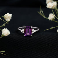 Emerald cut 1.4 carat amethyst engagement ring with diamond trio setting by Rosec Jewels, showcasing a vintage-style gold ring.