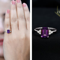 Rosec Jewels 1.4 Carat amethyst emerald cut engagement ring with diamond trio, showcasing a stunning purple gemstone and elegant design.