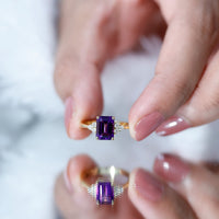 Emerald cut 1.4 carat amethyst engagement ring with diamond trio setting by Rosec Jewels, showcasing a sparkling gemstone and elegant band.