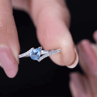 Rosec Jewels aquamarine and diamond promise ring with a bypass shank, showcasing vibrant blue gemstones and sparkling accents.