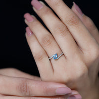 Rosec Jewels aquamarine and diamond promise ring with bypass shank, featuring a central aquamarine gemstone and sparkling diamonds.