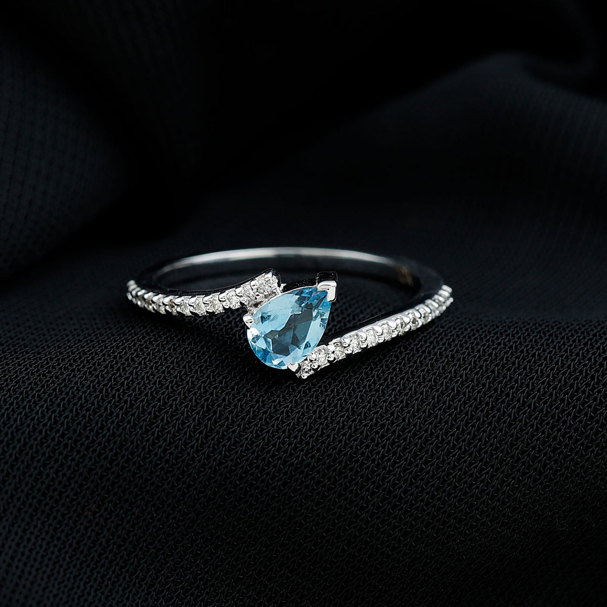 Rosec Jewels aquamarine and diamond promise ring featuring a bypass shank design with sparkling gemstones.