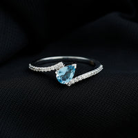 Rosec Jewels aquamarine and diamond promise ring featuring a bypass shank design with sparkling gemstones.