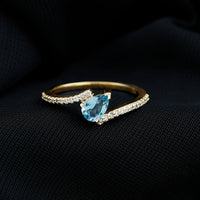 Rosec Jewels aquamarine and diamond promise ring with bypass shank, featuring a central aquamarine stone and sparkling diamonds.