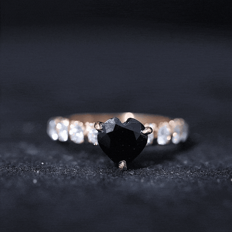 Natural 2 carat black spinel heart engagement ring with diamond side stones, featuring a rose gold band and intricate detailing.