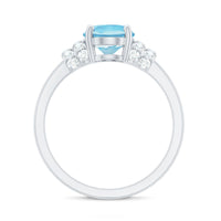 Oval cut aquamarine engagement ring with diamond collar by Rosec Jewels, featuring a 1 carat center stone and intricate band details.