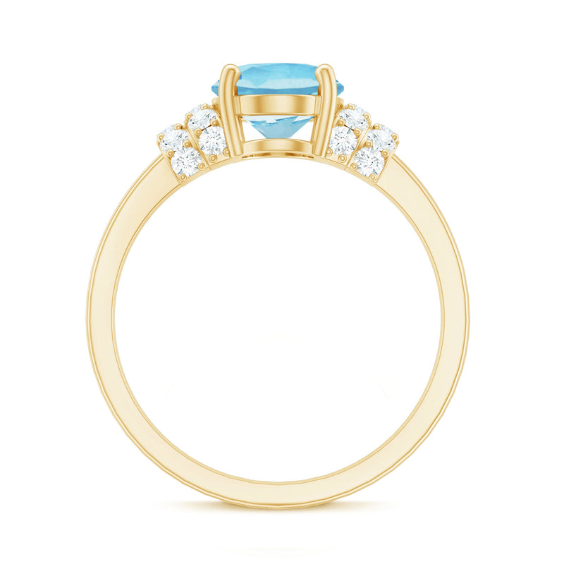 Oval cut aquamarine engagement ring with diamond collar from Rosec Jewels, featuring a 1 carat center stone and intricate band details.