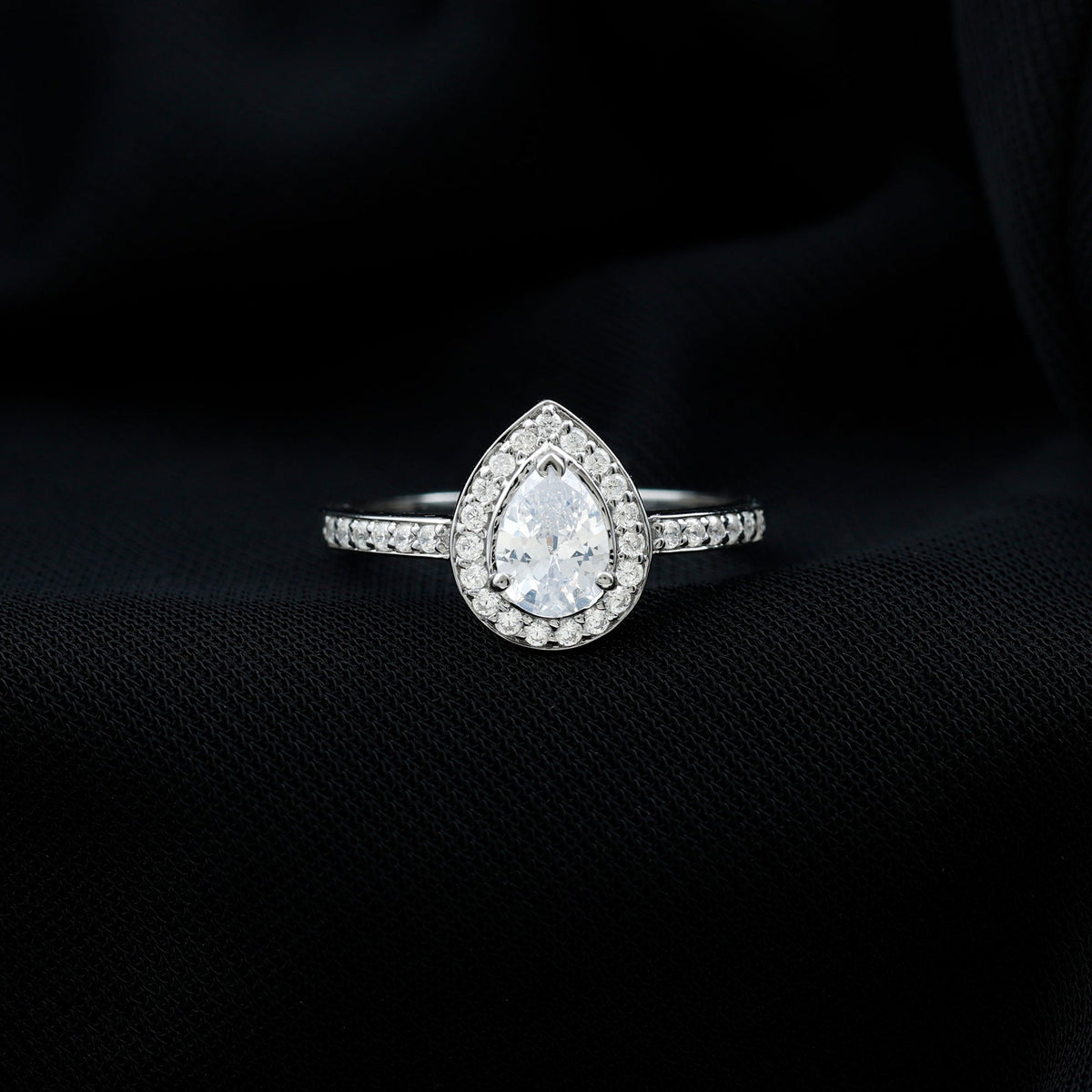 Rosec Jewels zircon teardrop halo engagement ring featuring a central teardrop-shaped zircon stone and intricate halo design.