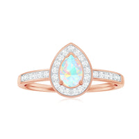 Natural 5x7mm opalescent teardrop engagement ring with diamond halo, showcasing a elegant design and sparkling accents.