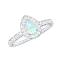 Natural 5x7mm opalescent teardrop engagement ring with diamond halo, featuring a sparkling center stone and elegant design.