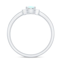 Natural 5x7mm opalescent teardrop engagement ring with diamond halo by Rosec Jewels, showcasing the elegant design and sparkling details.